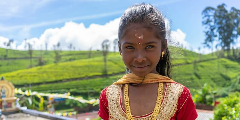 Sri Lankan girl standing in front of a field