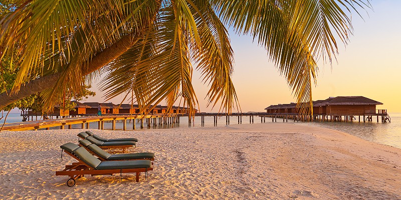 Loungers on Maldives beach - nature vacation background