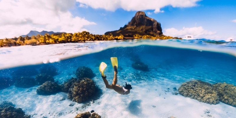 A woman goes snorkelling for underwater treasures