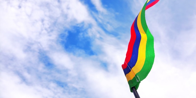 flag flapping in the wind against a cloudy blue sky background