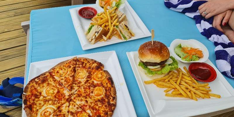 Three meals laid out on a sun lounger at Furaveri Island Resort & Spa