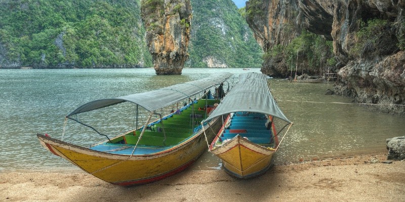 Two boats resting on the beach at Phang Nga Bay, Thailand
