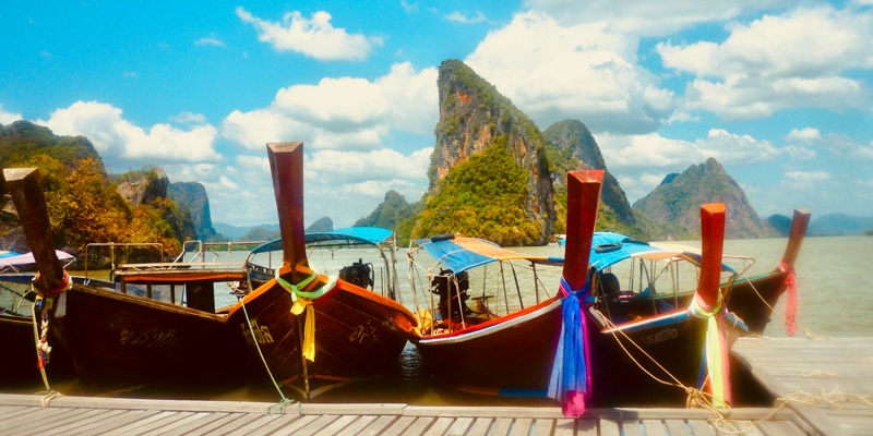 fishing boats wait at the jetty in Phang Nga Bay Thailand