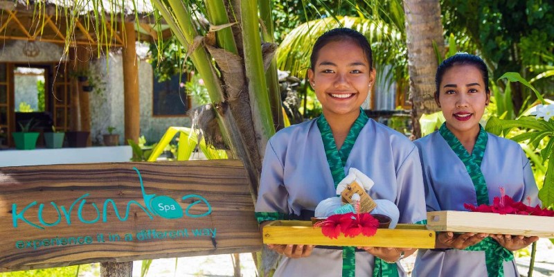 A smiling woman welcoming you to Kurumba spa