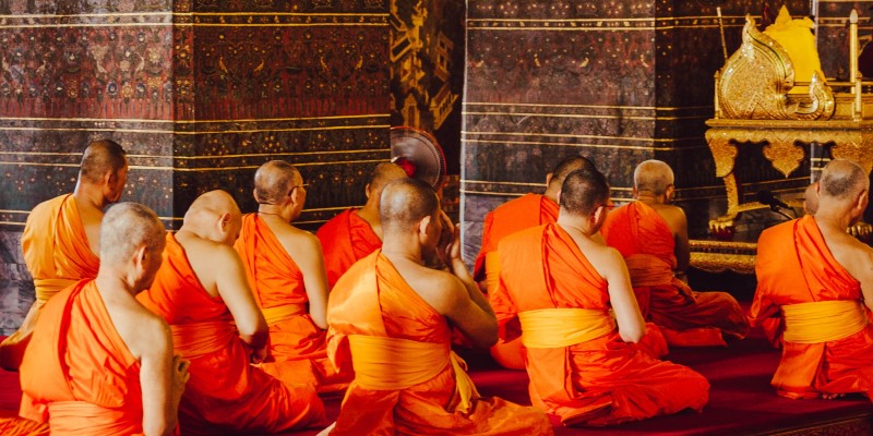 Buddhist monks in prayer in a temple