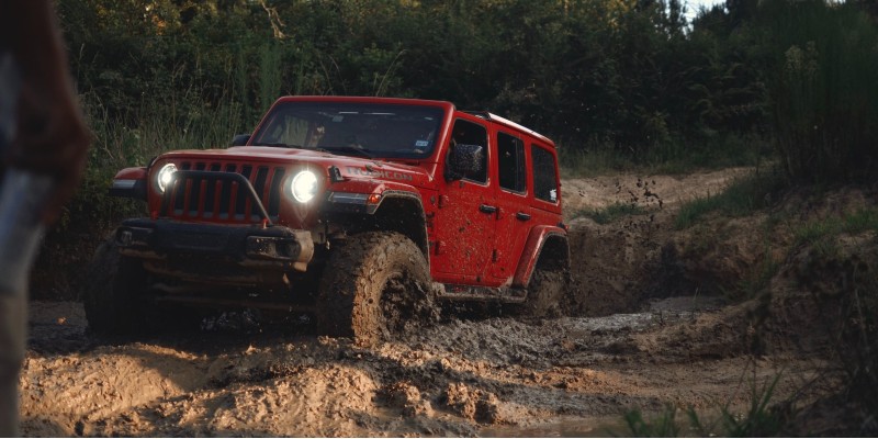 An SUV driving through the mud on an off-roading day