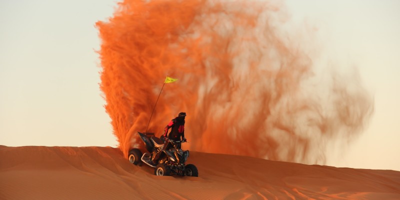 A man on an ATV in the desert