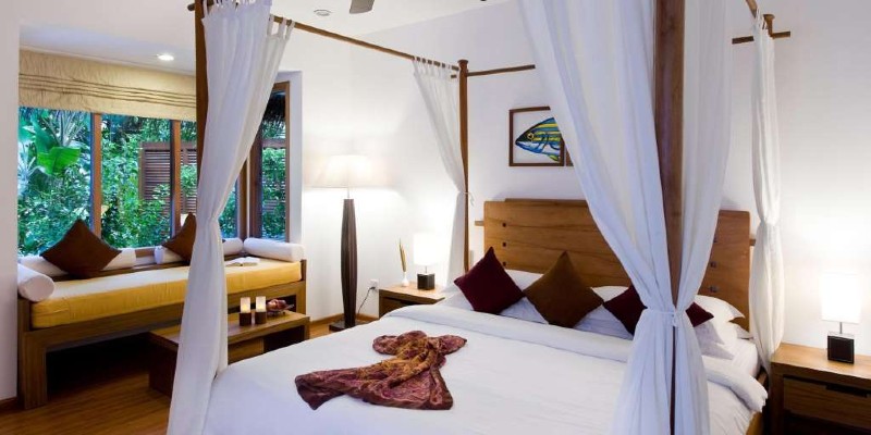 Inside the bedroom in a Kurumathi beach villa