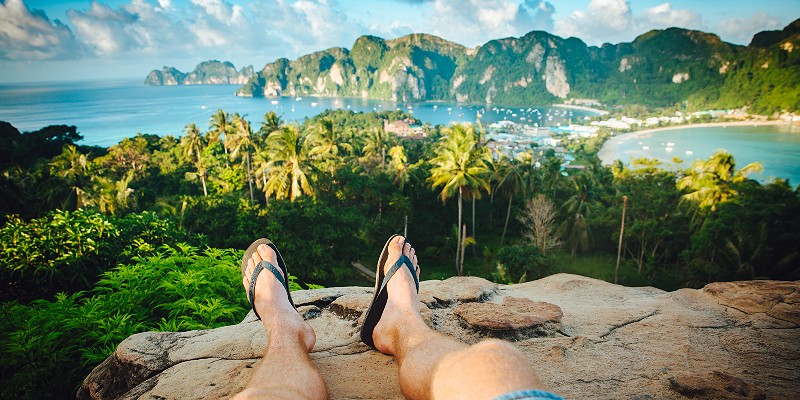 Man relaxing looking out over Thailand coastal scenery 