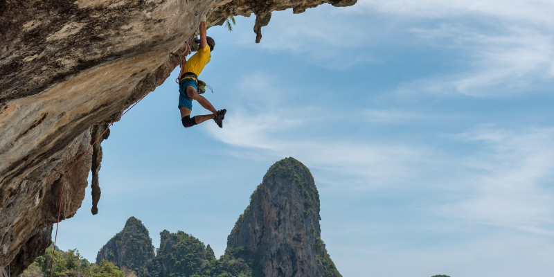 A daring rock-climber faces a challenge at Railay Beach