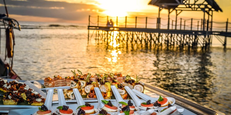 Sushi overlooking the water at sunset