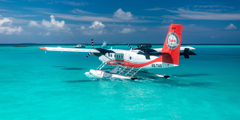 A seaplane on the blue waters. Photo by Ekmeds Photos on Unsplash