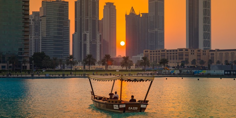 People sailing in an abra across Dubai Creek