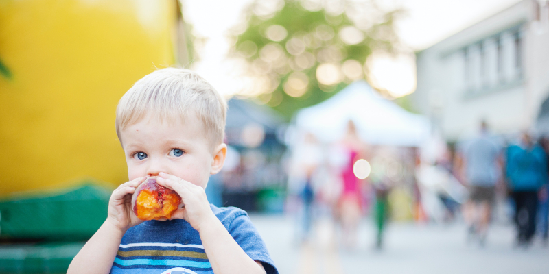 Little boy eating fruit