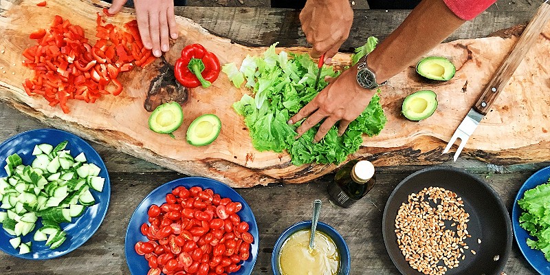 People chopping salad