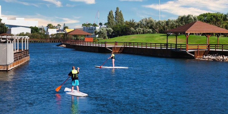 Two people paddleboarding on a private lake