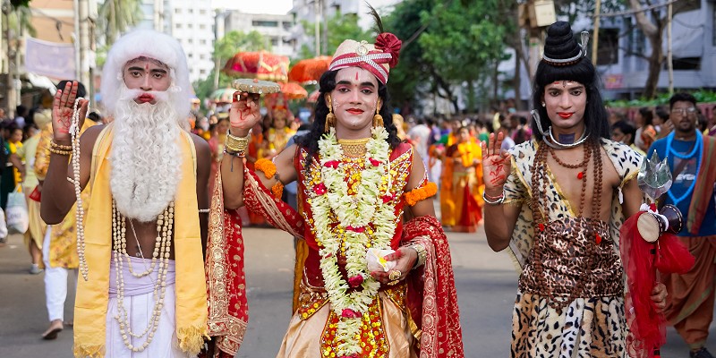 Three people dress up for a Sri Lankan festival